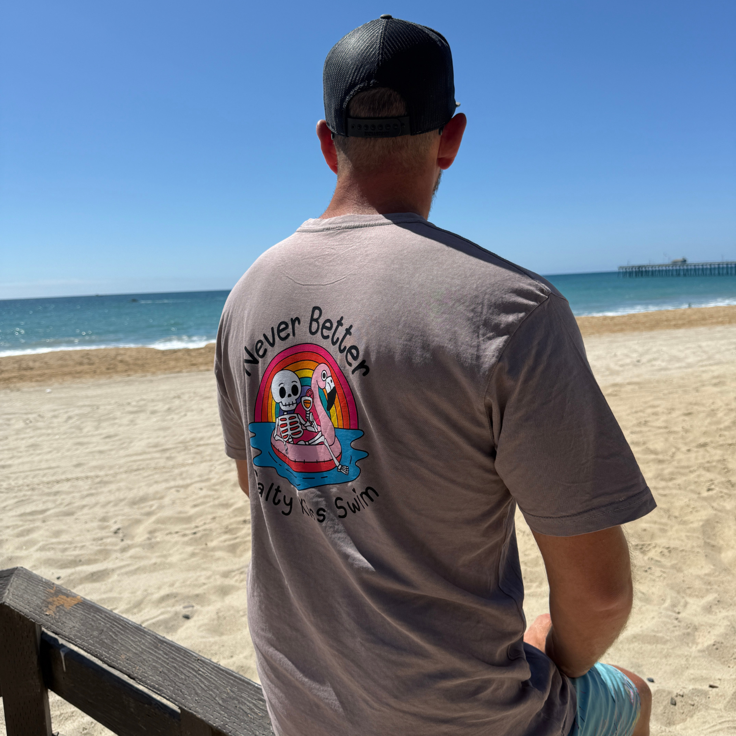 Man wearing a t-shirt with a graphic design on the beach